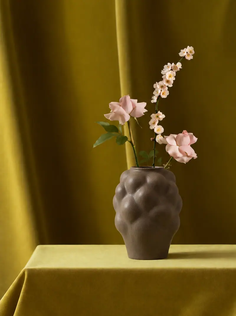 Ceramics arranged with flowers and fabric